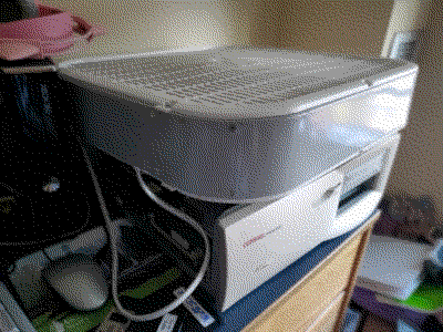 Box fan on top of an opened PC chassis