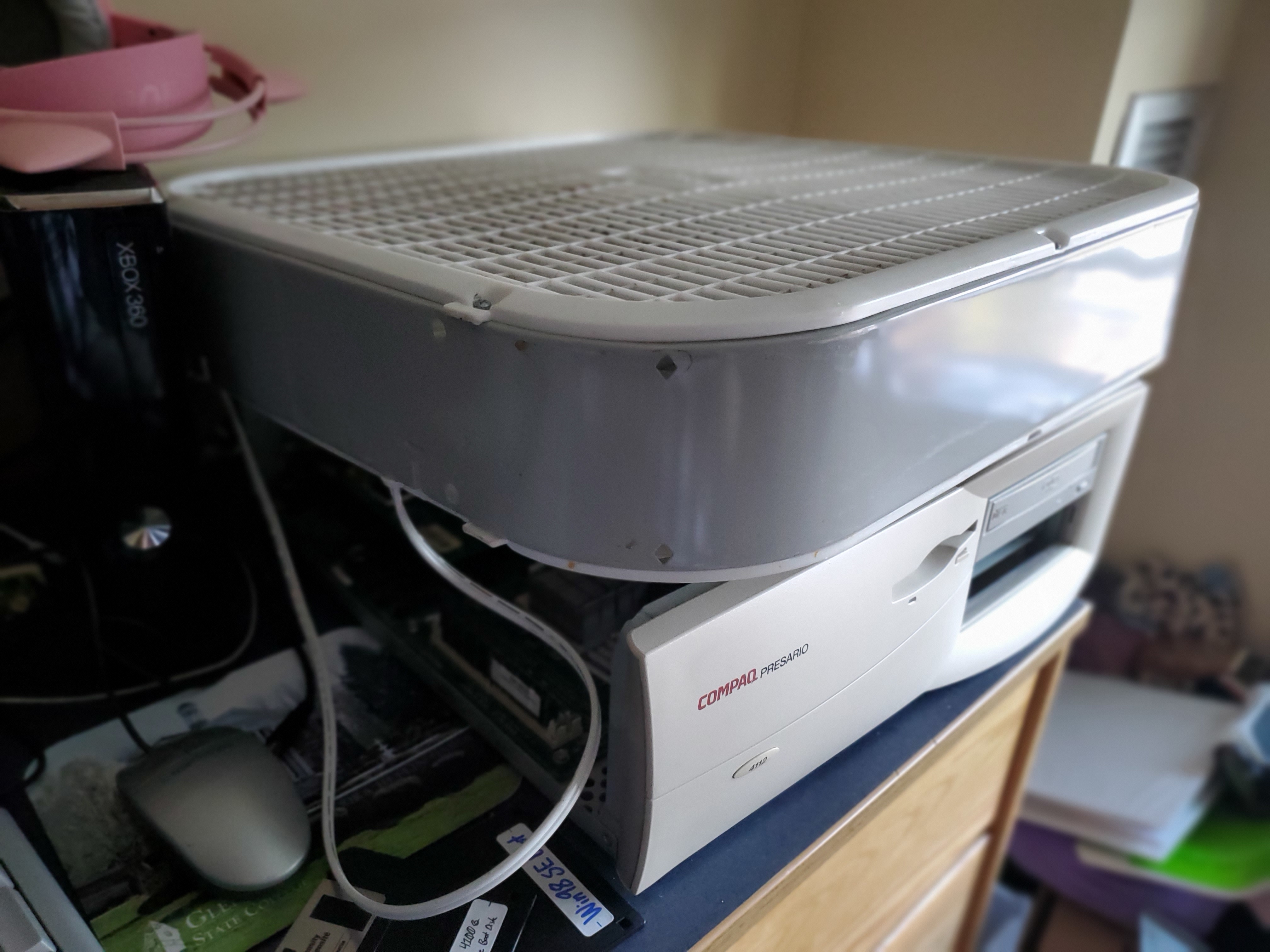 Box fan atop an open vintage PC